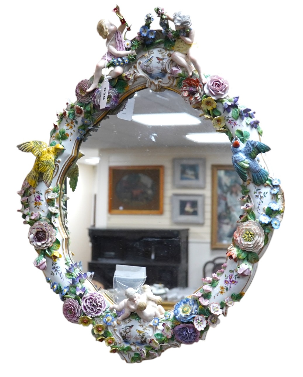 A Meissen style porcelain floral encrusted and figural mirror, 64cm high. Condition - fair, minor losses